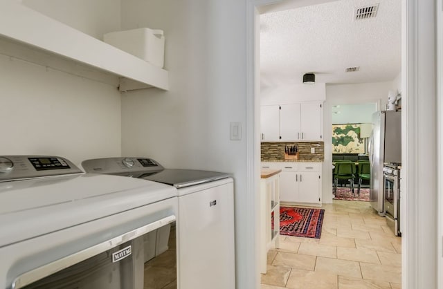 7000 Shadywood Dr, Austin, TX 78745 - laundry area featuring washer and dryer and a textured ceiling