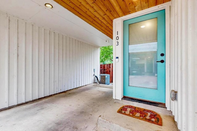 913 Duncan Ln Unit 103, Austin, TX 78705 - view of exterior entry with a patio, board and batten siding, and central AC