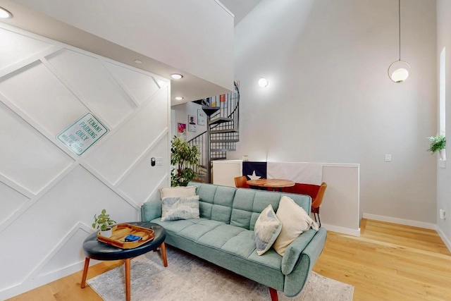 913 Duncan Ln Unit 103, Austin, TX 78705 - living room with stairway, wood finished floors, baseboards, and a high ceiling