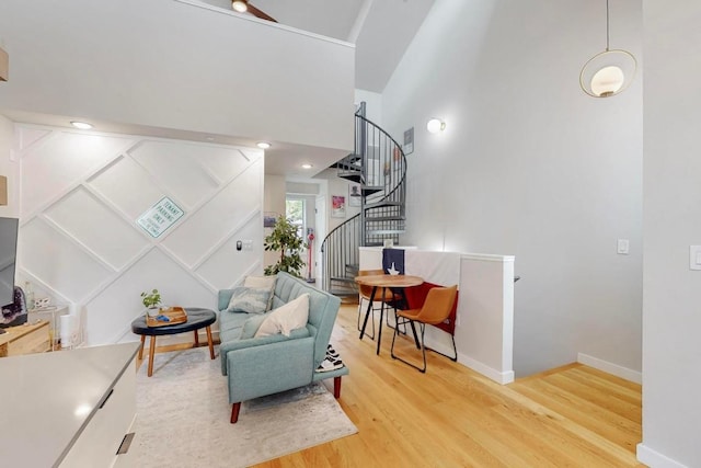 913 Duncan Ln Unit 103, Austin, TX 78705 - sitting room with wood finished floors, stairs, baseboards, and a towering ceiling