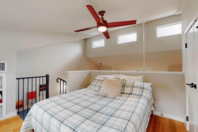 913 Duncan Ln Unit 103, Austin, TX 78705 - bedroom with multiple windows, wood finished floors, and baseboards