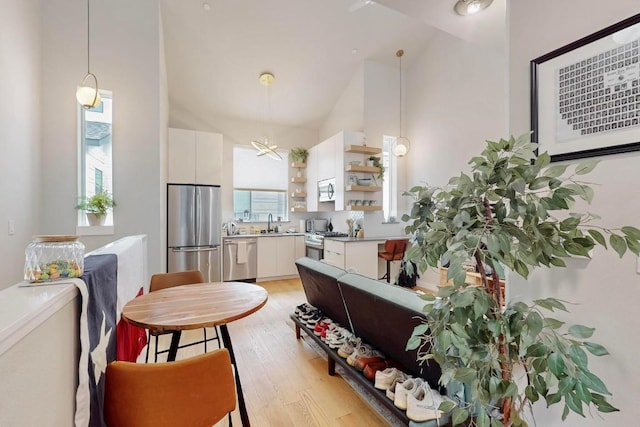 913 Duncan Ln Unit 103, Austin, TX 78705 - dining space with high vaulted ceiling and light wood-style floors