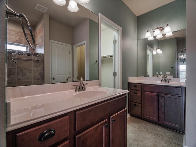 1501 Daylily Loop, Georgetown, TX 78626 - full bathroom with two vanities, tile patterned flooring, and a shower