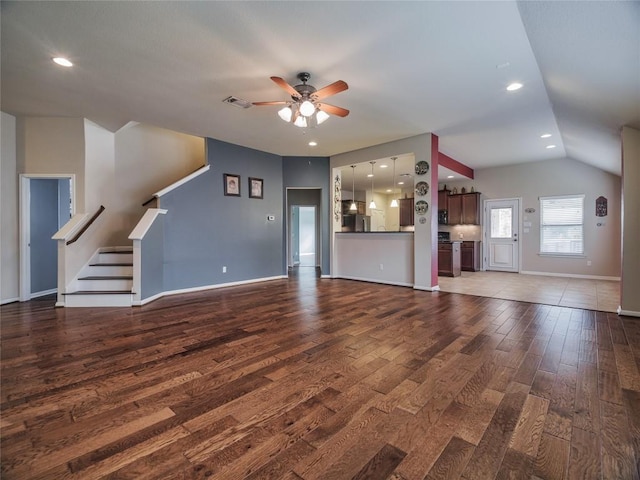 1501 Daylily Loop, Georgetown, TX 78626 - unfurnished living room with ceiling fan, wood finished floors, baseboards, lofted ceiling, and stairs