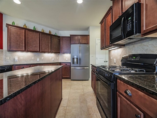 1501 Daylily Loop, Georgetown, TX 78626 - kitchen with black appliances, backsplash, dark stone countertops, light tile patterned floors, and recessed lighting