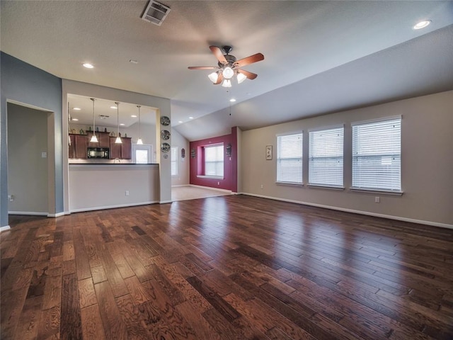 1501 Daylily Loop, Georgetown, TX 78626 - unfurnished living room with dark wood-type flooring, ceiling fan, baseboards, and lofted ceiling