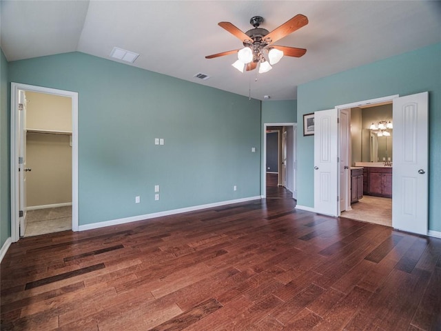 1501 Daylily Loop, Georgetown, TX 78626 - unfurnished bedroom featuring a walk in closet, wood finished floors, a chandelier, baseboards, and ensuite bathroom