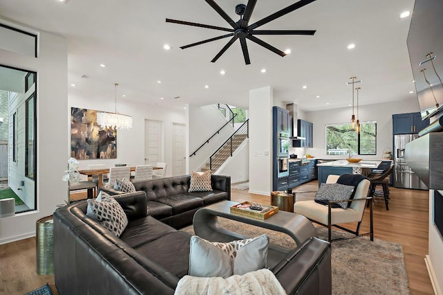 2312 Pruett St, Austin, TX 78703 - living room featuring light wood-style floors, a chandelier, stairs, recessed lighting, and ceiling fan