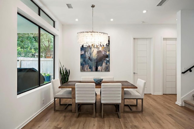 2312 Pruett St, Austin, TX 78703 - dining room with wood finished floors, stairs, a chandelier, baseboards, and recessed lighting