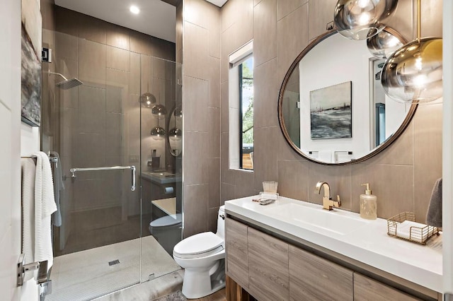 2312 Pruett St, Austin, TX 78703 - full bath with tile walls, a stall shower, toilet, vanity, and backsplash