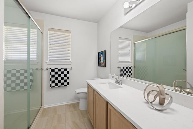 2803 Glenwood Trl, Cedar Park, TX 78613 - bathroom featuring a stall shower, toilet, vanity, and baseboards