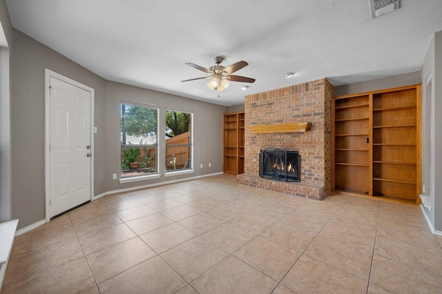 11814 Barrington Way, Austin, TX 78759 - unfurnished living room with tile patterned floors, a brick fireplace, ceiling fan, and baseboards