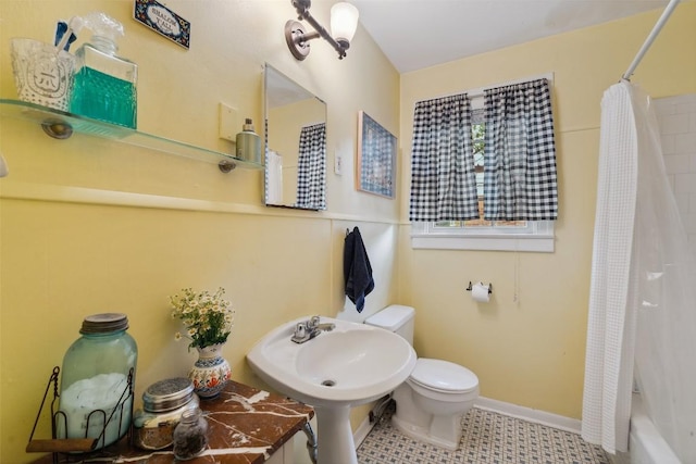 3003 Dancy St, Austin, TX 78722 - bathroom featuring shower / bath combo with shower curtain and tile patterned flooring