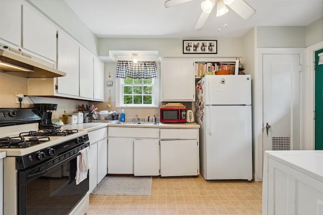 3003 Dancy St, Austin, TX 78722 - kitchen with freestanding refrigerator, black gas range, white cabinetry, light countertops, and light floors
