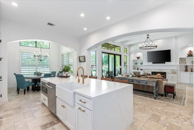 213 Black Wolf Run, Austin, TX 78738 - kitchen featuring a sink, a chandelier, stainless steel dishwasher, recessed lighting, and white cabinets