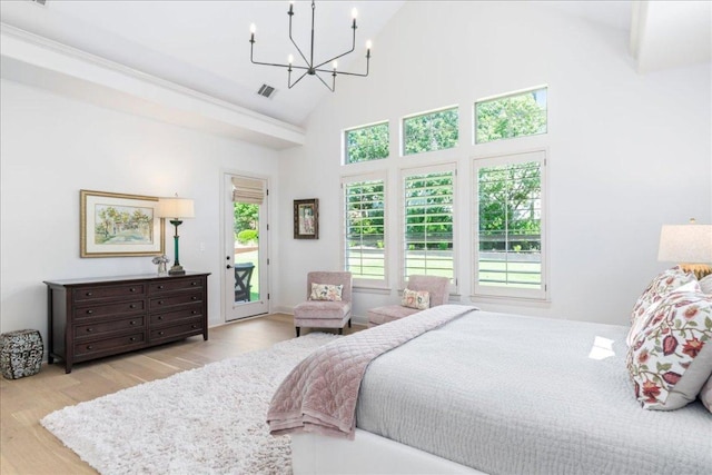 213 Black Wolf Run, Austin, TX 78738 - bedroom with access to outside, wood finished floors, high vaulted ceiling, and a chandelier