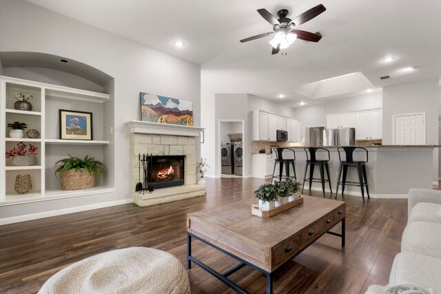 6307 Clairmont Dr, Austin, TX 78749 - living area featuring washer and clothes dryer, ceiling fan, dark wood finished floors, a fireplace, and recessed lighting