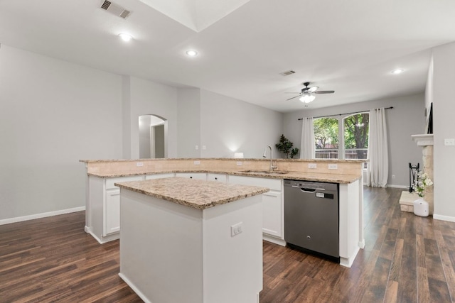 6307 Clairmont Dr, Austin, TX 78749 - kitchen featuring stainless steel dishwasher, a center island, a ceiling fan, dark wood-style flooring, and arched walkways