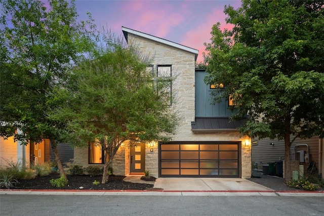 2807 Del Curto Rd Unit G, Austin, TX 78704 - contemporary house with stone siding, an attached garage, and concrete driveway