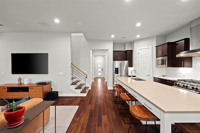 2807 Del Curto Rd Unit G, Austin, TX 78704 - kitchen featuring stainless steel appliances, a sink, an island with sink, dark wood-type flooring, and light countertops
