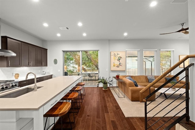 2807 Del Curto Rd Unit G, Austin, TX 78704 - kitchen with light countertops, recessed lighting, dark brown cabinetry, dark wood finished floors, and backsplash