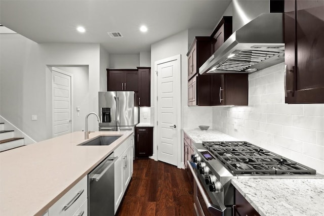 2807 Del Curto Rd Unit G, Austin, TX 78704 - kitchen featuring wall chimney range hood, stainless steel appliances, a sink, dark wood-style flooring, and backsplash