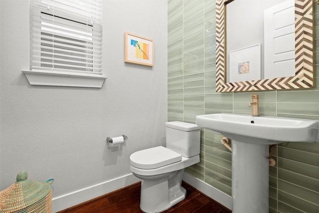 2807 Del Curto Rd Unit G, Austin, TX 78704 - half bathroom with wood finished floors, toilet, tile walls, and baseboards