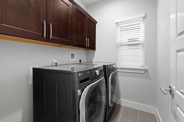2807 Del Curto Rd Unit G, Austin, TX 78704 - laundry room with washer and clothes dryer, baseboards, cabinet space, and tile patterned floors