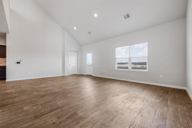 10820 Gonzales Ranger Pass, Austin, TX 78754 - unfurnished room featuring high vaulted ceiling, wood finished floors, baseboards, and recessed lighting