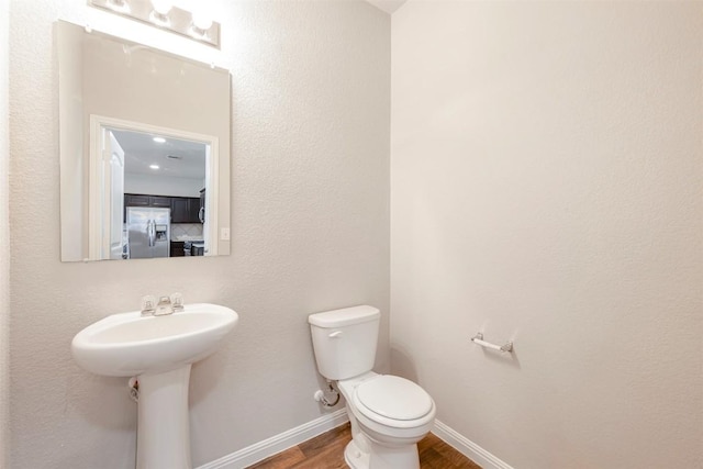 10820 Gonzales Ranger Pass, Austin, TX 78754 - half bath with wood finished floors, toilet, and baseboards