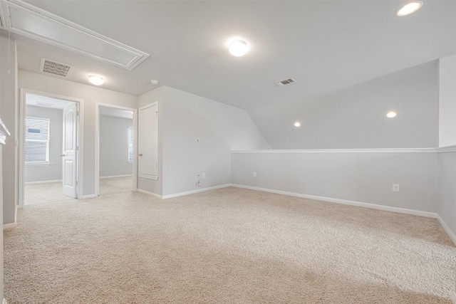 10820 Gonzales Ranger Pass, Austin, TX 78754 - additional living space with attic access, light colored carpet, baseboards, lofted ceiling, and recessed lighting