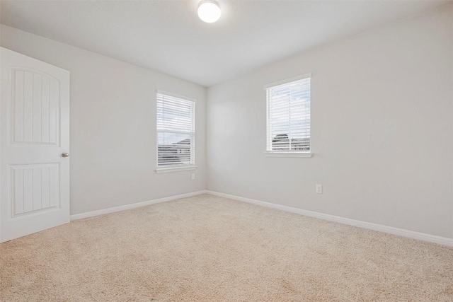 10820 Gonzales Ranger Pass, Austin, TX 78754 - empty room featuring plenty of natural light, carpet flooring, and baseboards