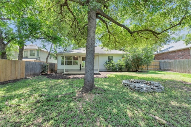 1908 Paradise Ridge Dr, Round Rock, TX 78665 - back of property featuring an outdoor fire pit and a chimney