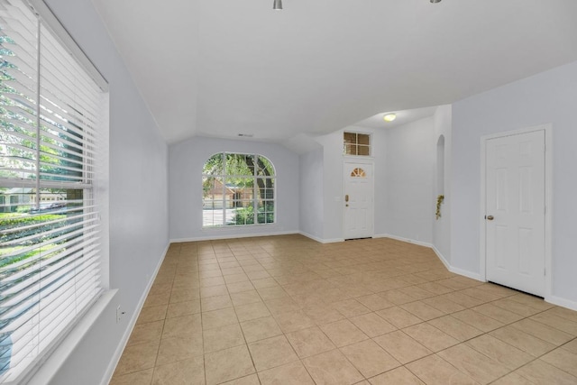 1908 Paradise Ridge Dr, Round Rock, TX 78665 - empty room featuring light tile patterned floors, vaulted ceiling, and baseboards