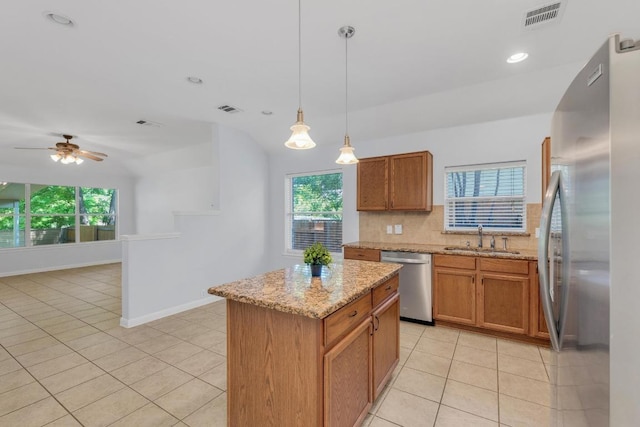 1908 Paradise Ridge Dr, Round Rock, TX 78665 - kitchen with appliances with stainless steel finishes, a sink, light tile patterned floors, decorative backsplash, and healthy amount of natural light
