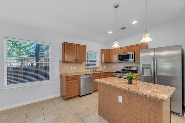 1908 Paradise Ridge Dr, Round Rock, TX 78665 - kitchen with stainless steel appliances, a sink, decorative backsplash, light tile patterned floors, and decorative light fixtures