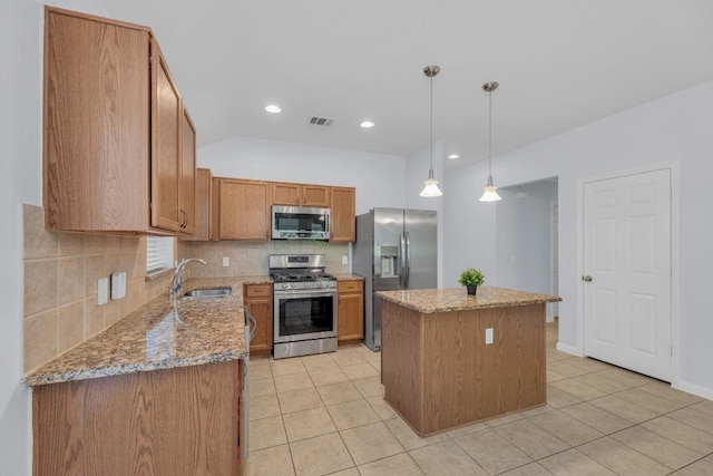 1908 Paradise Ridge Dr, Round Rock, TX 78665 - kitchen with stainless steel appliances, a sink, a kitchen island, backsplash, and light tile patterned flooring