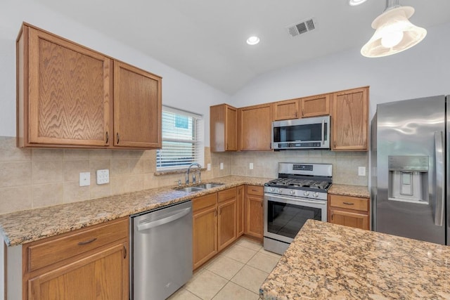 1908 Paradise Ridge Dr, Round Rock, TX 78665 - kitchen with appliances with stainless steel finishes, a sink, vaulted ceiling, decorative backsplash, and light tile patterned floors