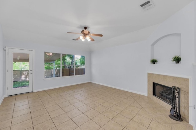 1908 Paradise Ridge Dr, Round Rock, TX 78665 - unfurnished living room with plenty of natural light, a ceiling fan, a tiled fireplace, and baseboards