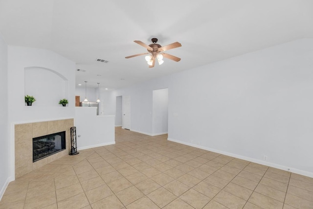 1908 Paradise Ridge Dr, Round Rock, TX 78665 - unfurnished living room with ceiling fan, a tiled fireplace, and baseboards