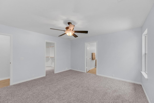 1908 Paradise Ridge Dr, Round Rock, TX 78665 - unfurnished bedroom with light colored carpet, a walk in closet, baseboards, and ceiling fan