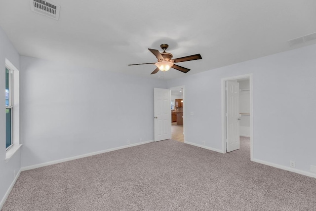 1908 Paradise Ridge Dr, Round Rock, TX 78665 - unfurnished bedroom featuring light colored carpet, baseboards, and a walk in closet