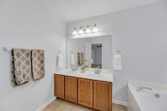 1908 Paradise Ridge Dr, Round Rock, TX 78665 - bathroom with double vanity, baseboards, tile patterned flooring, and a bath