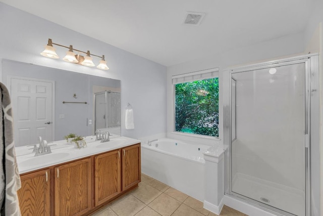 1908 Paradise Ridge Dr, Round Rock, TX 78665 - bathroom with tile patterned floors, a garden tub, double vanity, and a shower stall