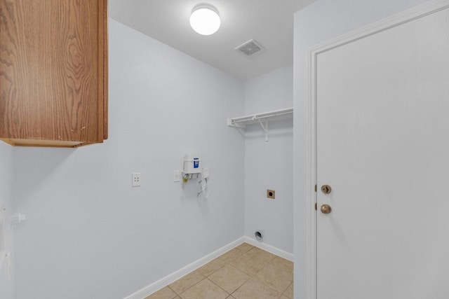 1908 Paradise Ridge Dr, Round Rock, TX 78665 - laundry area featuring electric dryer hookup, baseboards, and light tile patterned floors