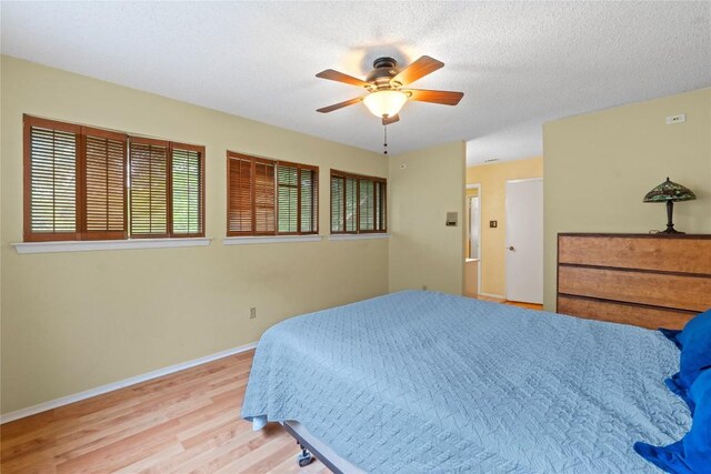 11708 Barrington Way, Austin, TX 78759 - bedroom featuring wood finished floors and ceiling fan