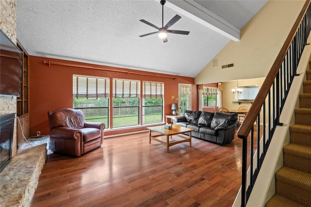 11708 Barrington Way, Austin, TX 78759 - living room with stairs, beamed ceiling, a ceiling fan, wood finished floors, and a fireplace