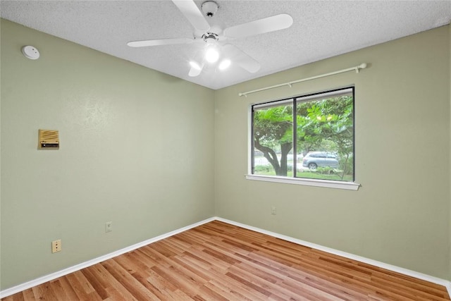 11708 Barrington Way, Austin, TX 78759 - spare room featuring wood finished floors, baseboards, a textured ceiling, a smoke detector, and a ceiling fan