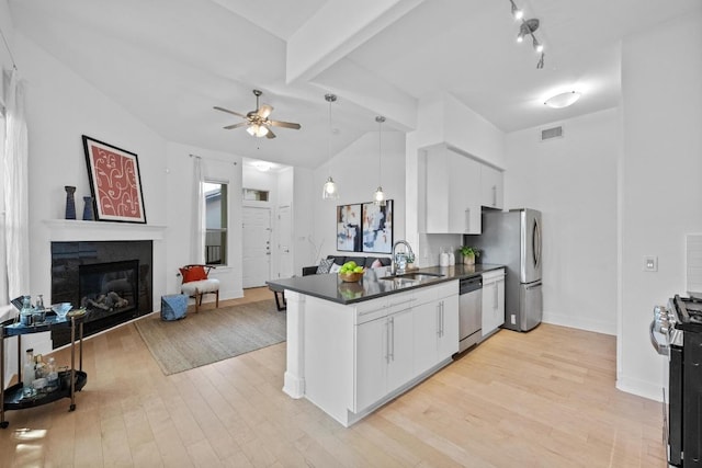 2216 Thornton Rd Unit 221, Austin, TX 78704 - kitchen featuring stainless steel appliances, dark countertops, a peninsula, a sink, and ceiling fan