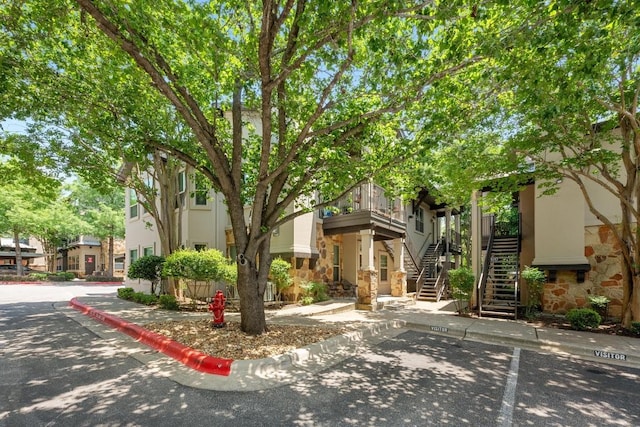 2216 Thornton Rd Unit 221, Austin, TX 78704 - view of property featuring stairway, stone siding, and stucco siding